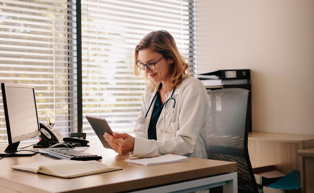 A front desk staff member reviewing a patient's upcoming appointment
