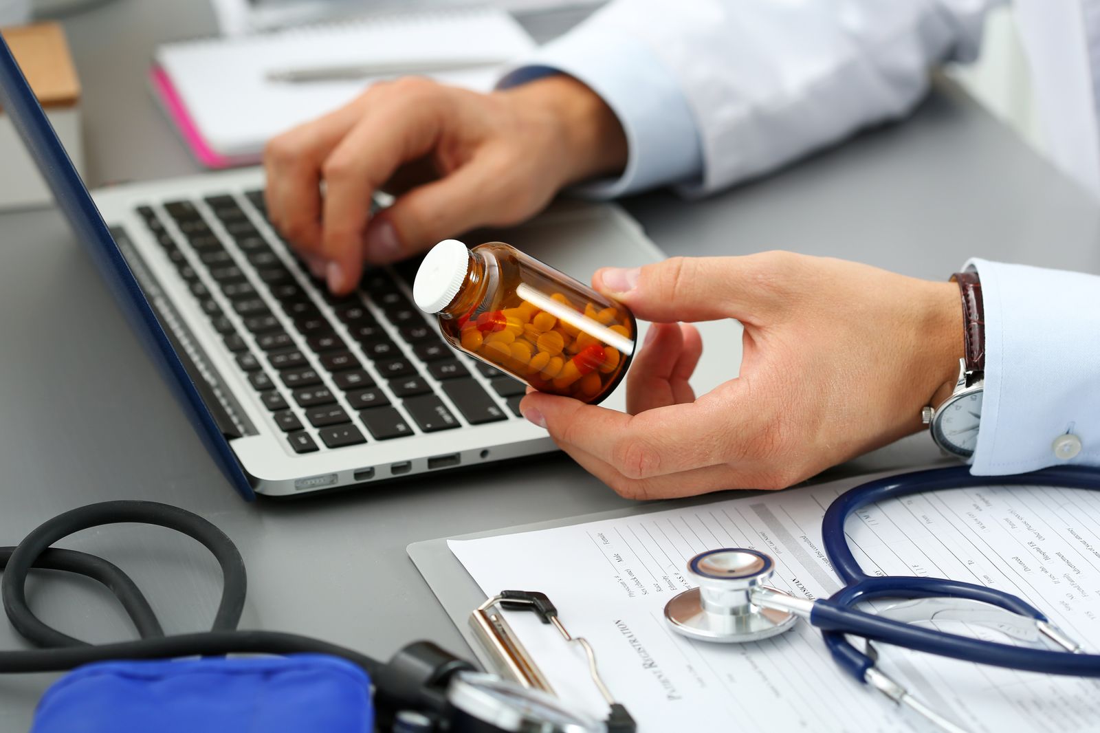 Physician reviewing a medication and checking it against the chart before sending it electronically